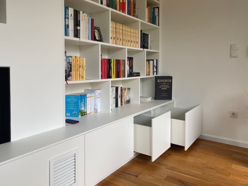 Schönes Bücherregal nach Maß mit geöffneten Schubkästen Bücherregal nach Maß in Weiß und offenen Schubkästen